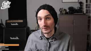 Screenshot of Snutt in a beanie, looking direct into camera, camera mirrored with the Marshall amps visible in the blurred background.
